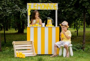 Boy and girl selling lemonade picture.